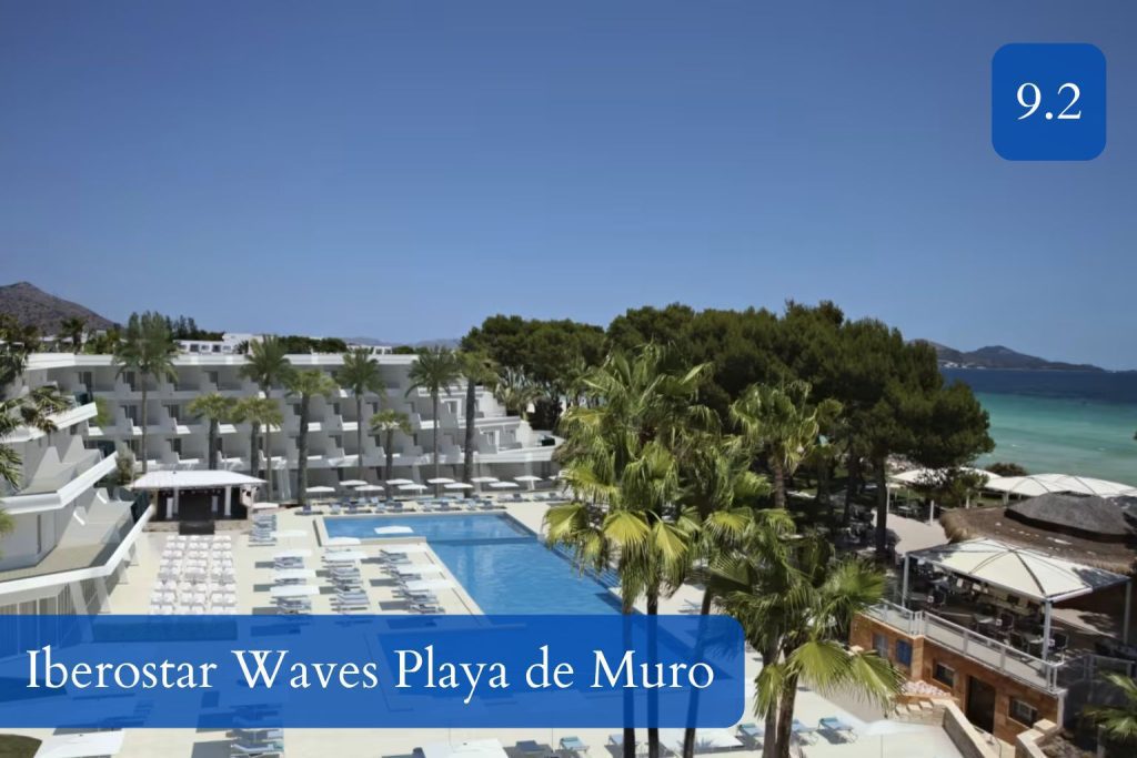 broad sandy beach, family pool area and low-rise resort buildings