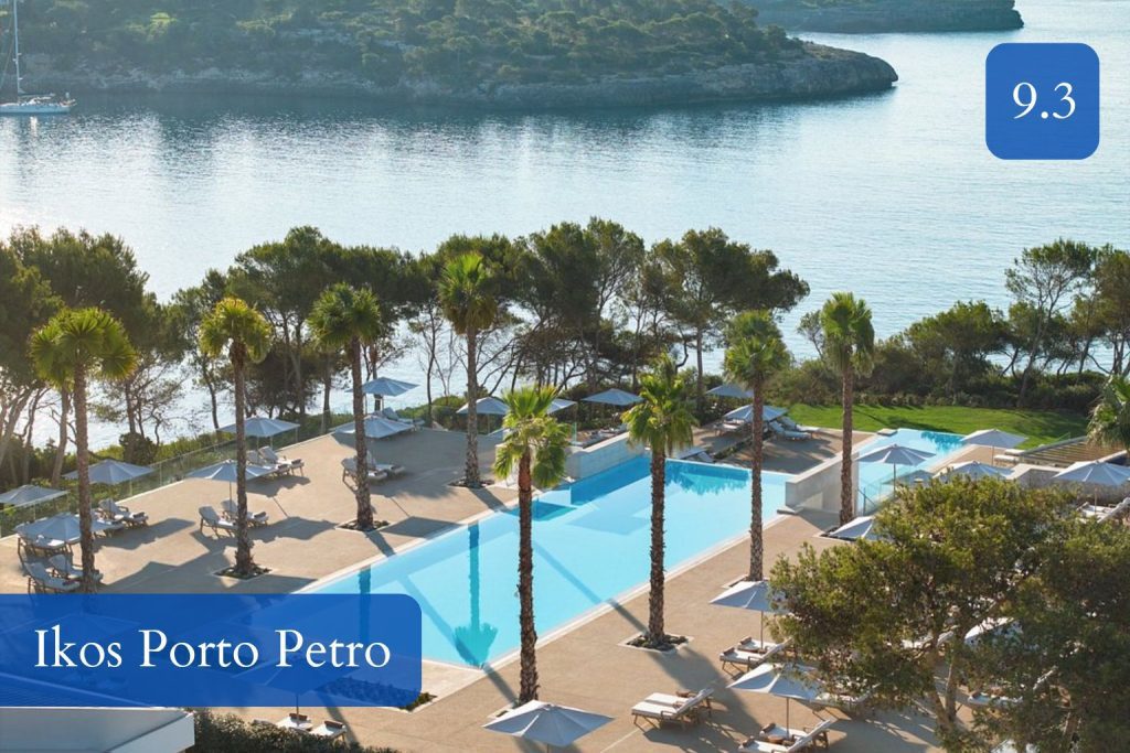 pine-fringed seafront pools and a calm bay at Portopetro
