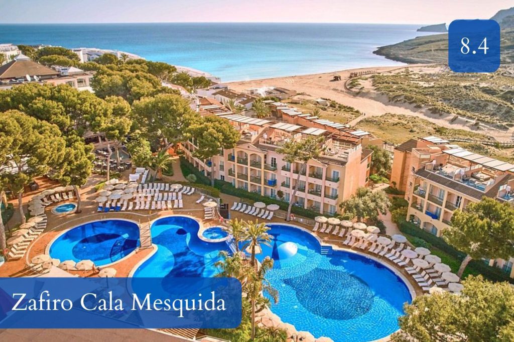 resort pools with the dune-backed Cala Mesquida beach nearby