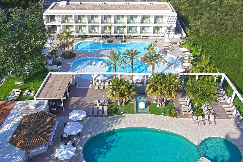  Multiple outdoor swimming pools, palm trees, sun terraces, and hotel buildings at BG Caballero in Playa de Palma / Can Pastilla edge