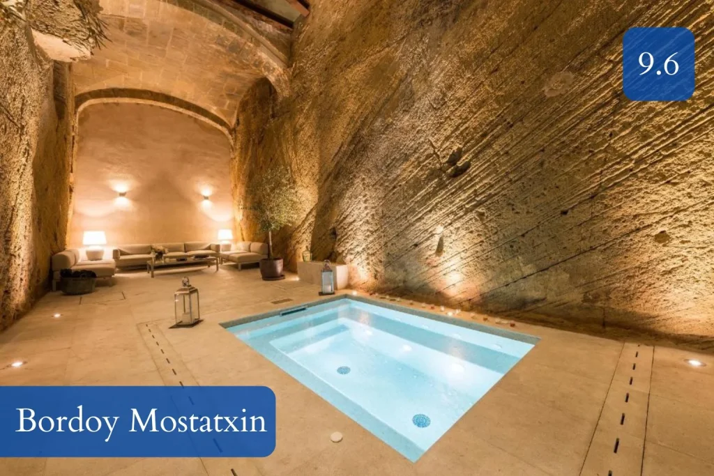 Underground spa and jacuzzi area at Bordoy Mostatxins, set within historic stone architecture in Alcúdia Old Town, Mallorca.