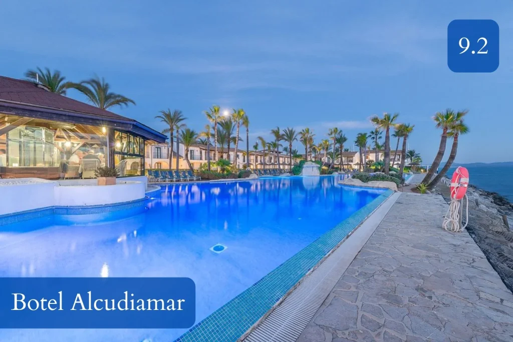 Seafront swimming pool and marina setting at Botel Alcudiamar in Port d’Alcúdia, Mallorca.