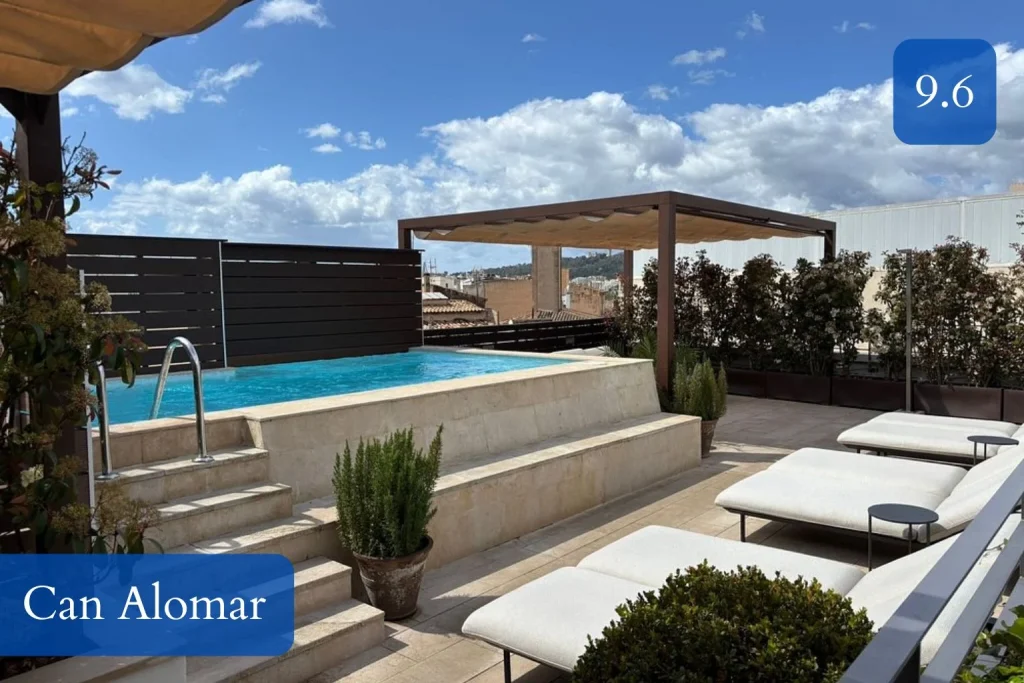 Rooftop pool with sun loungers, shaded lounge area, and city views at Can Alomar Hotel on Passeig del Born in Palma de Mallorca