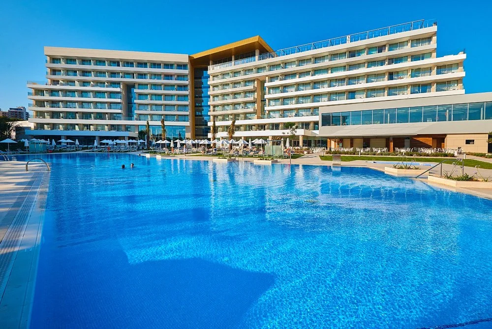 Modern outdoor swimming pool and hotel exterior at Hipotels Playa de Palma Palace in Playa de Palma, Mallorca.