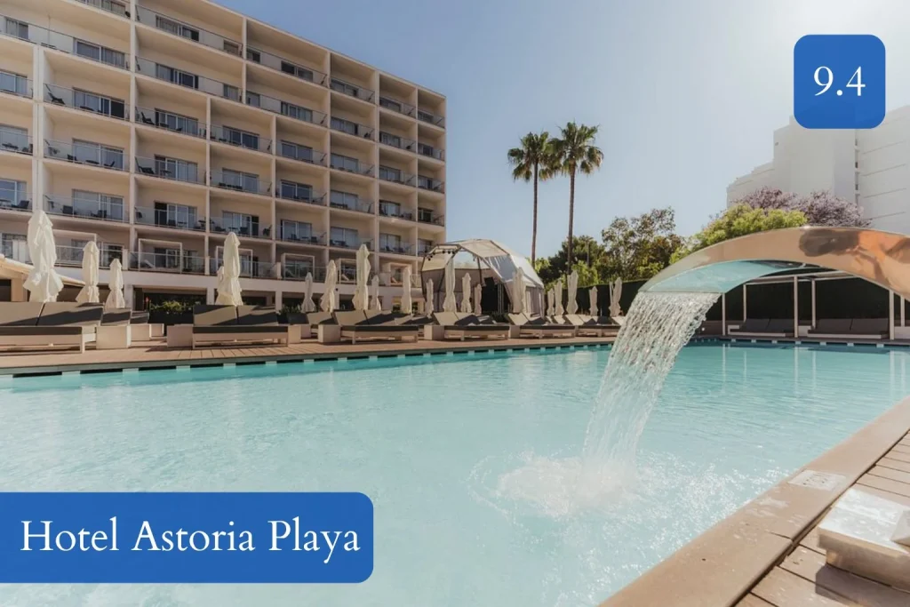 Outdoor pool area with waterfall feature at Hotel Astoria Playa in Port d’Alcúdia, Mallorca