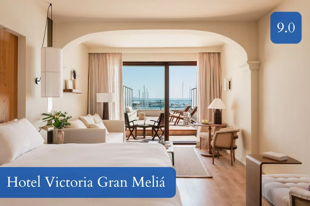 Elegant guest room at Hotel Victoria Gran Meliá featuring a king-size bed, seating area, private terrace, and views of the marina and Palma Bay along the Paseo Marítimo in Mallorca