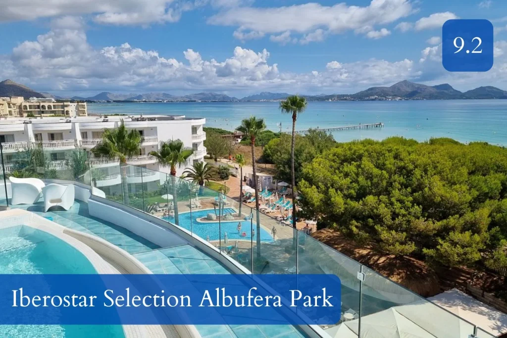 Rooftop pool with glass railing overlooking Playa de Muro beach and the bay at Iberostar Selection Albufera Park in Playa de Muro, Mallorca