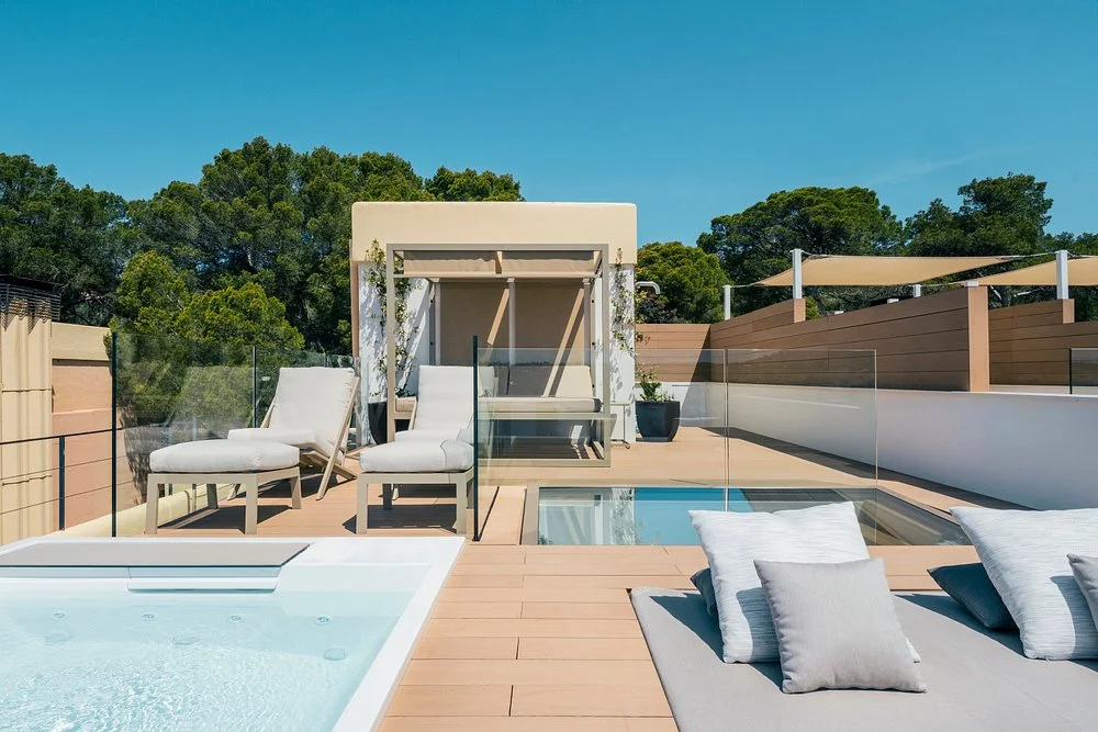 Private rooftop terrace with hot tub and Balinese bed at Iberostar Selection Jardín del Sol Suites in Costa de la Calma, Mallorca.