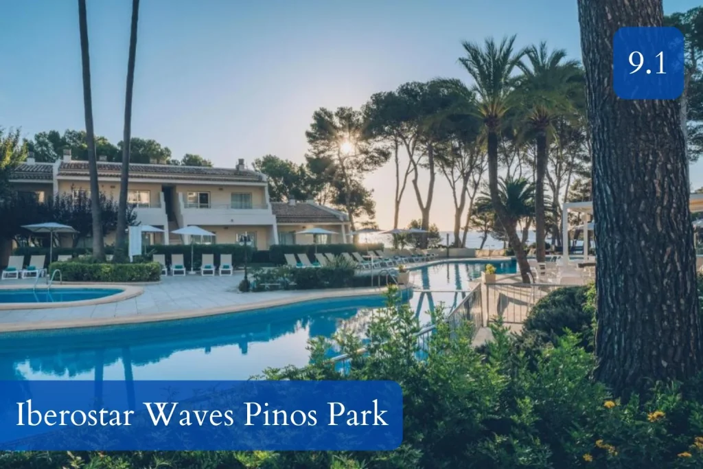 Outdoor pool surrounded by palm trees and gardens at Iberostar Waves Pinos Park in Font de Sa Cala, Mallorca