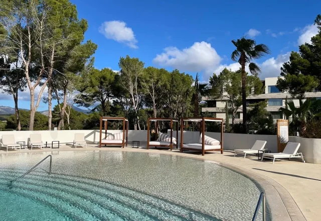 Outdoor pool with cabanas at Kimpton Aysla Mallorca in Santa Ponsa, Mallorca