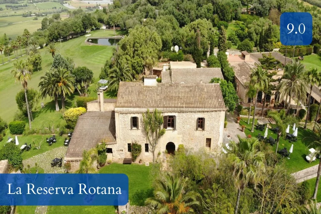 Aerial view of the historic estate surrounded by gardens and golf course at La Reserva Rotana in Manacor, Mallorca