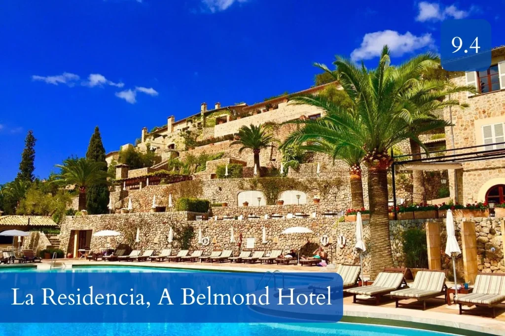 Scenic outdoor swimming pool surrounded by traditional stone terraces and Mediterranean gardens at La Residencia, A Belmond Hotel in Deià, Mallorca.