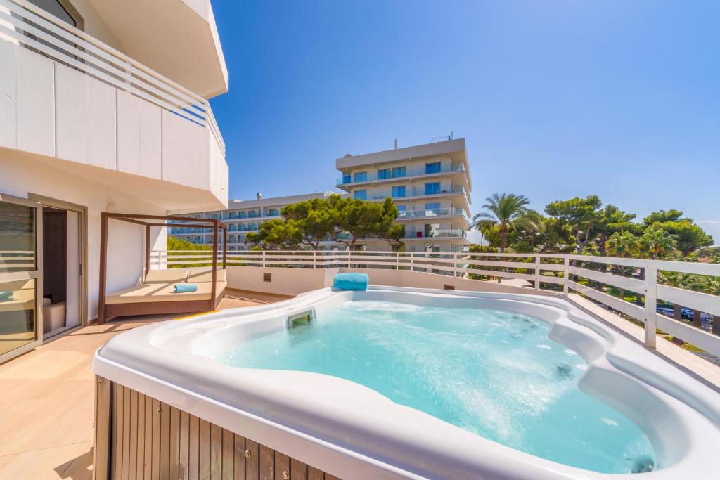 Luxury suite with a private jacuzzi and spacious sun terrace at Playa Esperanza Resort in Playa de Muro, Mallorca.