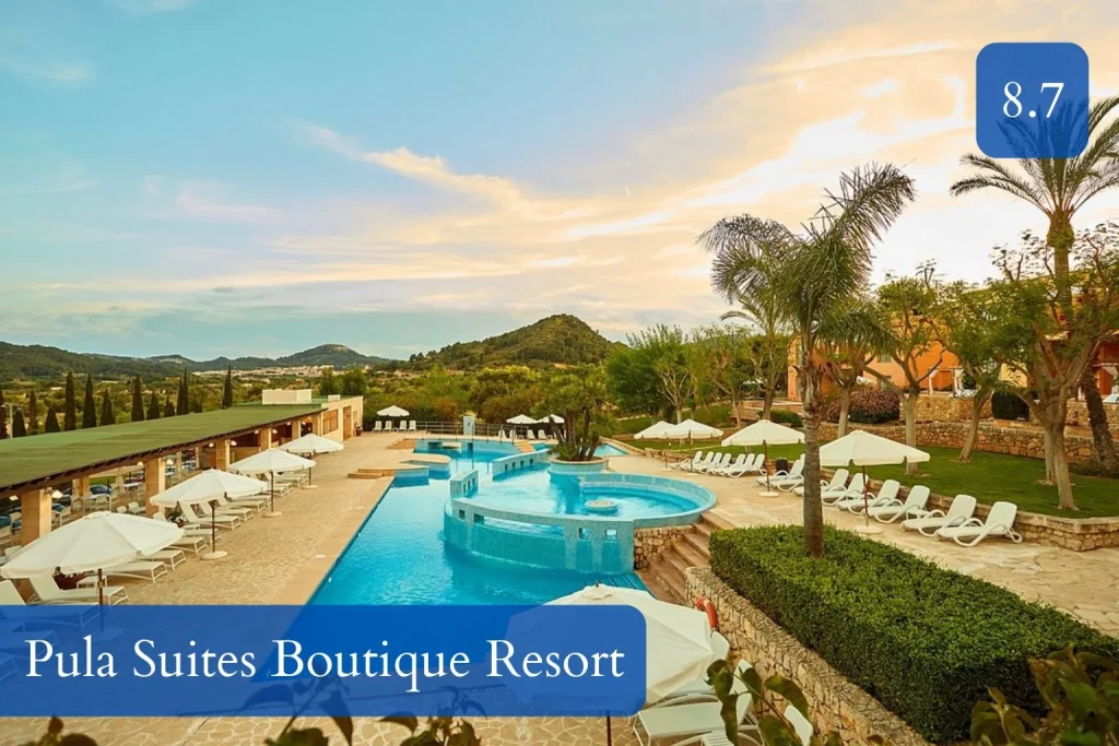 Outdoor pool with sun loungers and mountain views at Pula Suites Boutique Resort in Son Servera, Mallorca