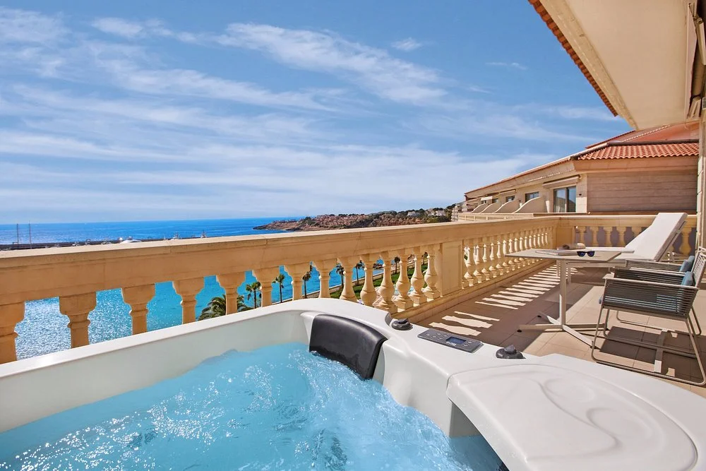 Sea-view suite with private hot tub on the terrace at Pure Salt Port Adriano in Port Adriano, Mallorca.