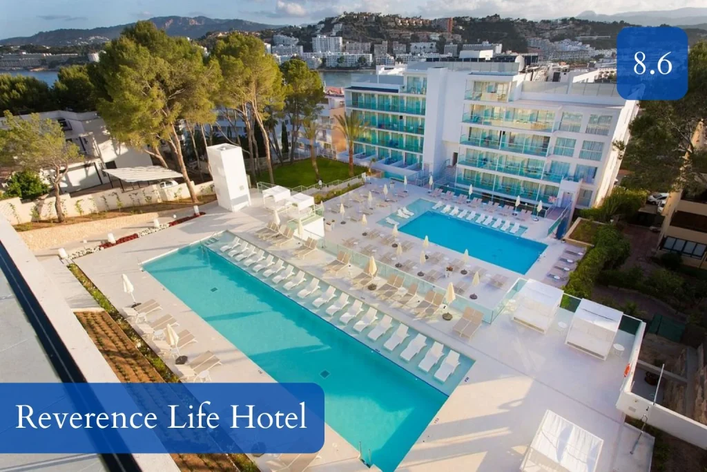 Aerial view of two outdoor pools surrounded by sun loungers and cabanas at Reverence Life Hotel in Santa Ponsa, Mallorca