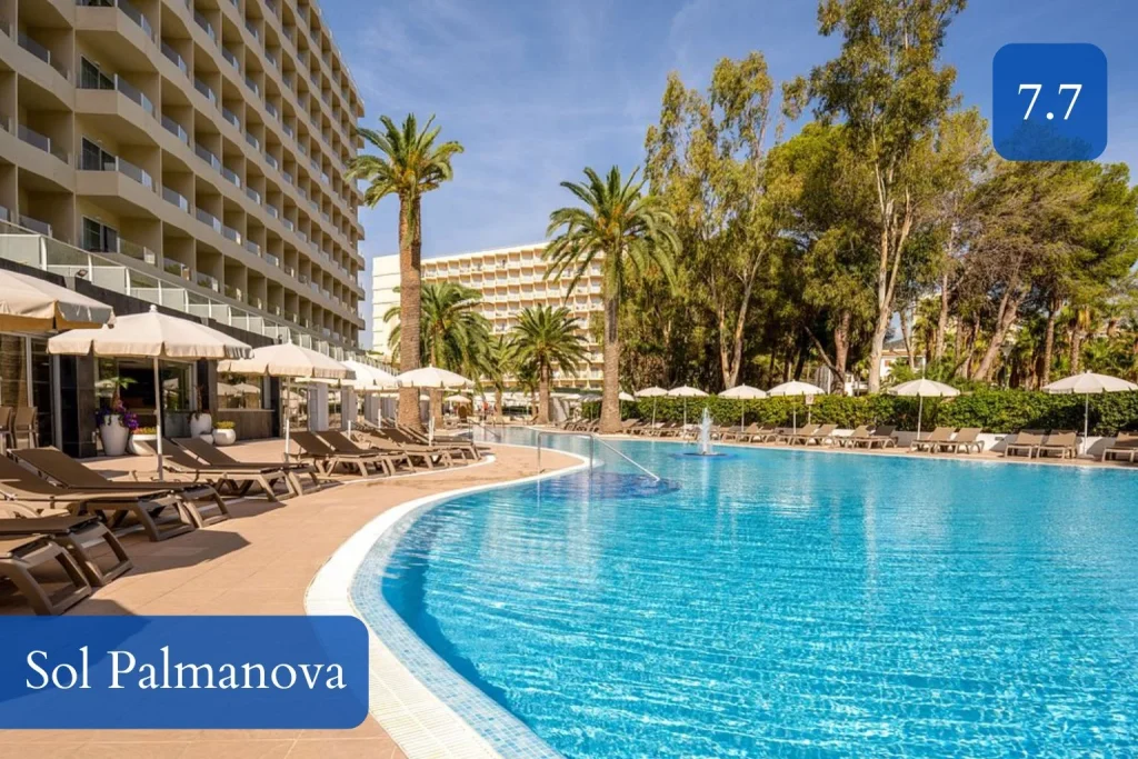 Large outdoor swimming pool surrounded by palm trees at Sol Palmanova in Palmanova, Mallorca