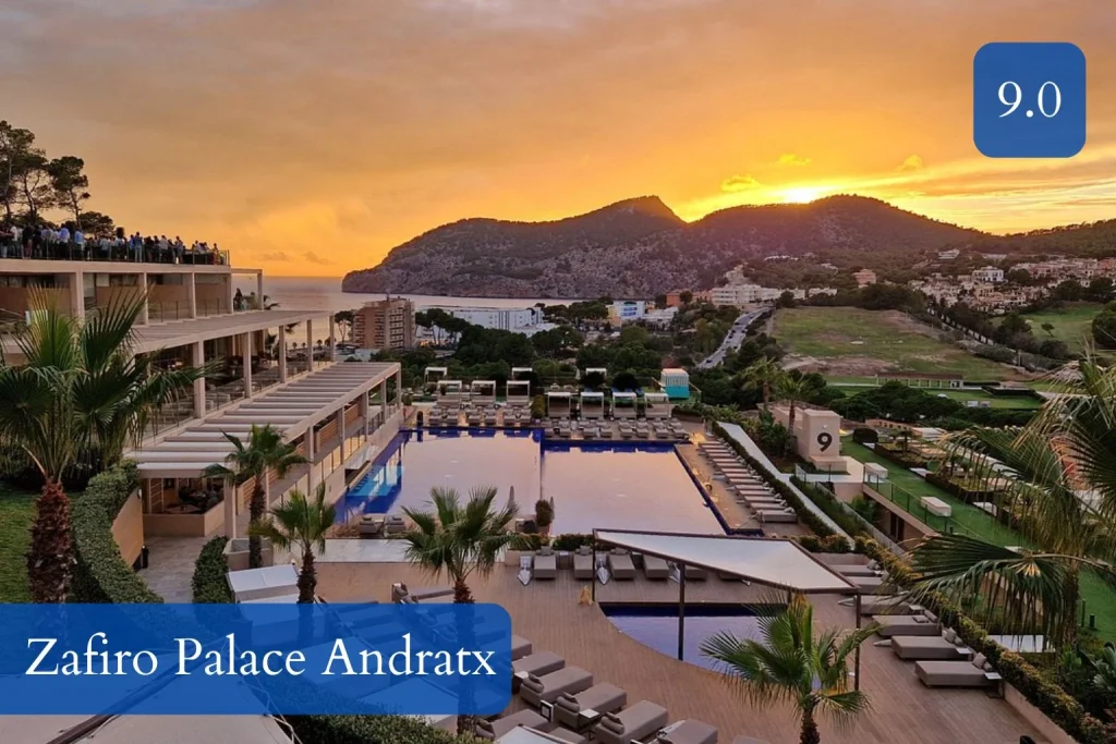 Panoramic sunset view overlooking the outdoor pool and surrounding mountains at Zafiro Palace Andratx in Camp de Mar, Mallorca.