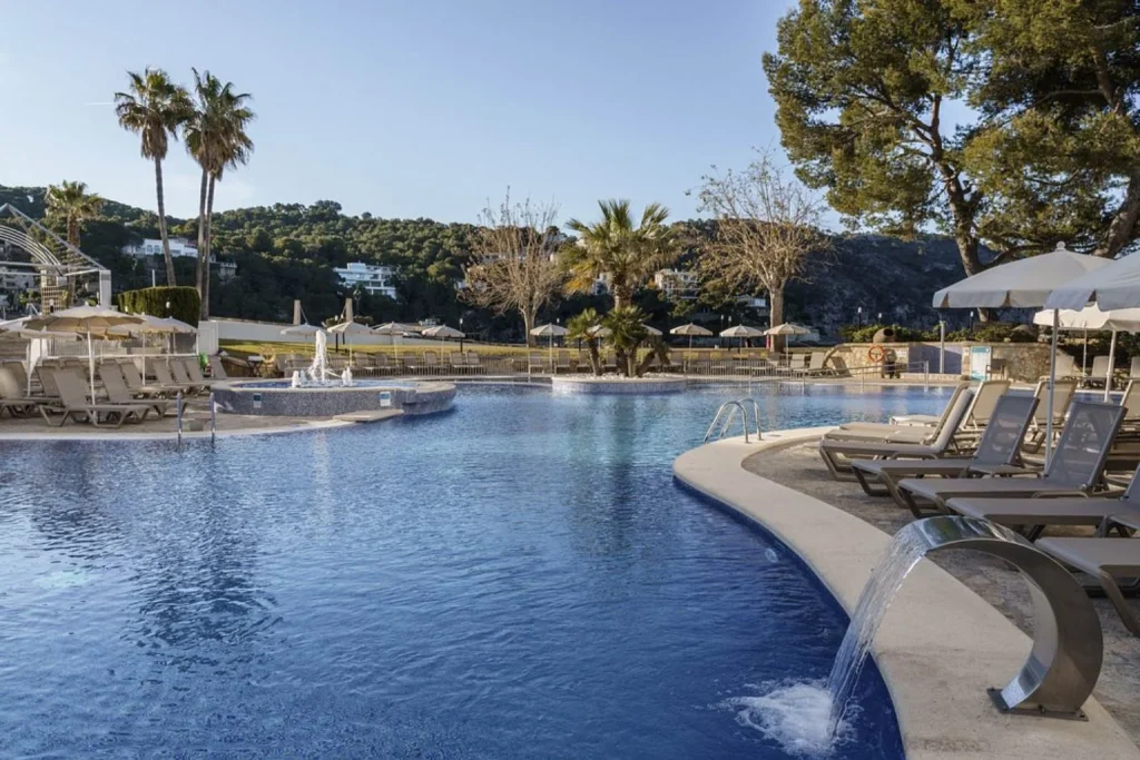 Swimming pool with a hydromassage feature and sun terrace at Alua Gran Camp de Mar in Camp de Mar, Mallorca.