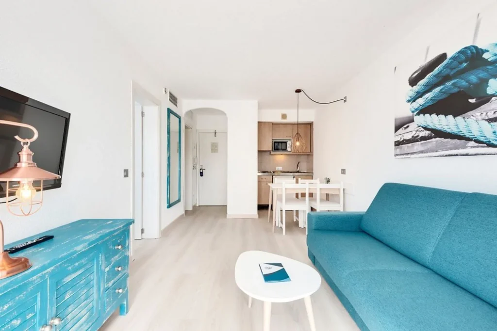 Spacious one-bedroom apartment with a kitchenette and separate living area at Aparthotel Alcudia Garden in Port d'Alcúdia, Mallorca.