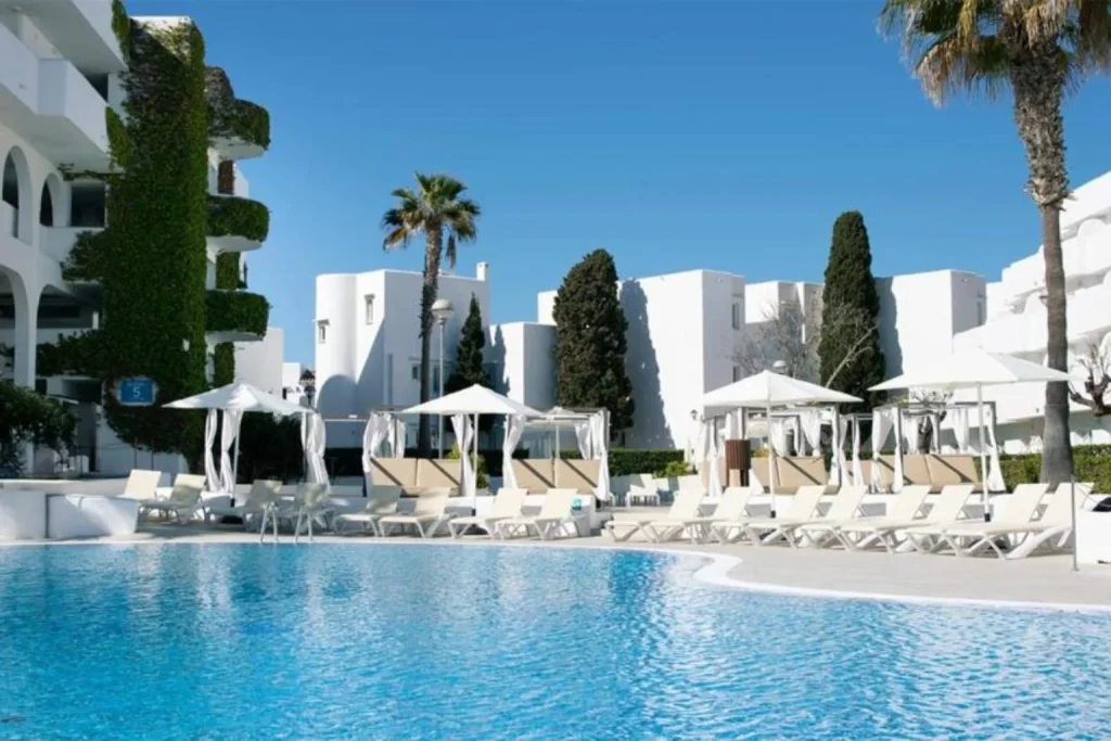 Main outdoor swimming pool with sun loungers and cabanas at Blue Sea Club Martha's Resort in Cala d'Or, Mallorca.