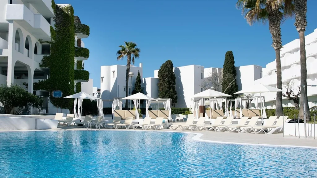 Main pool with sun loungers and cabanas at BLUESEA Club Marthas in Cala d'Or, Mallorca.