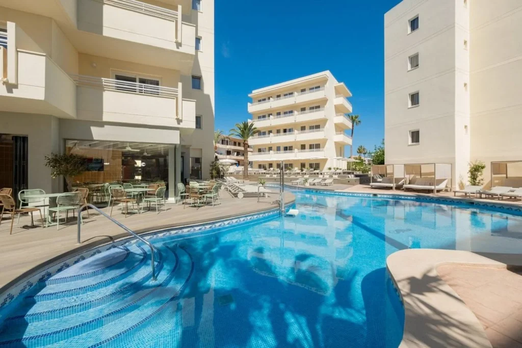 Outdoor pool with hotel building at Cabot Cap de Mar Spa in Cala Millor
