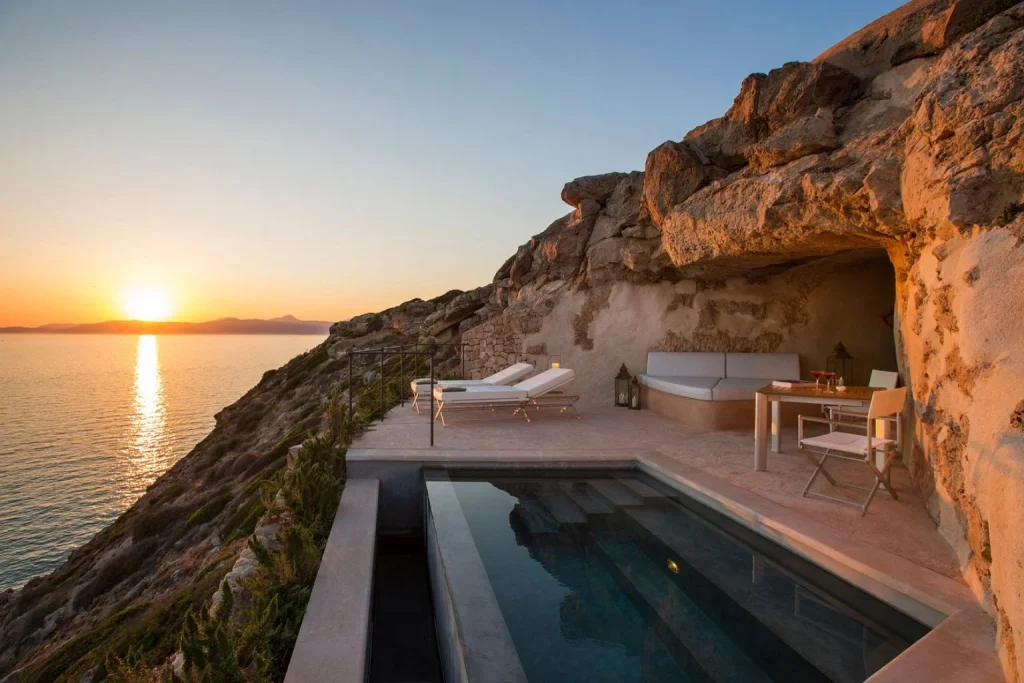 Clifftop private pool with a sunset sea view and outdoor lounge terrace at Cap Rocat in Cala Blava, Mallorca