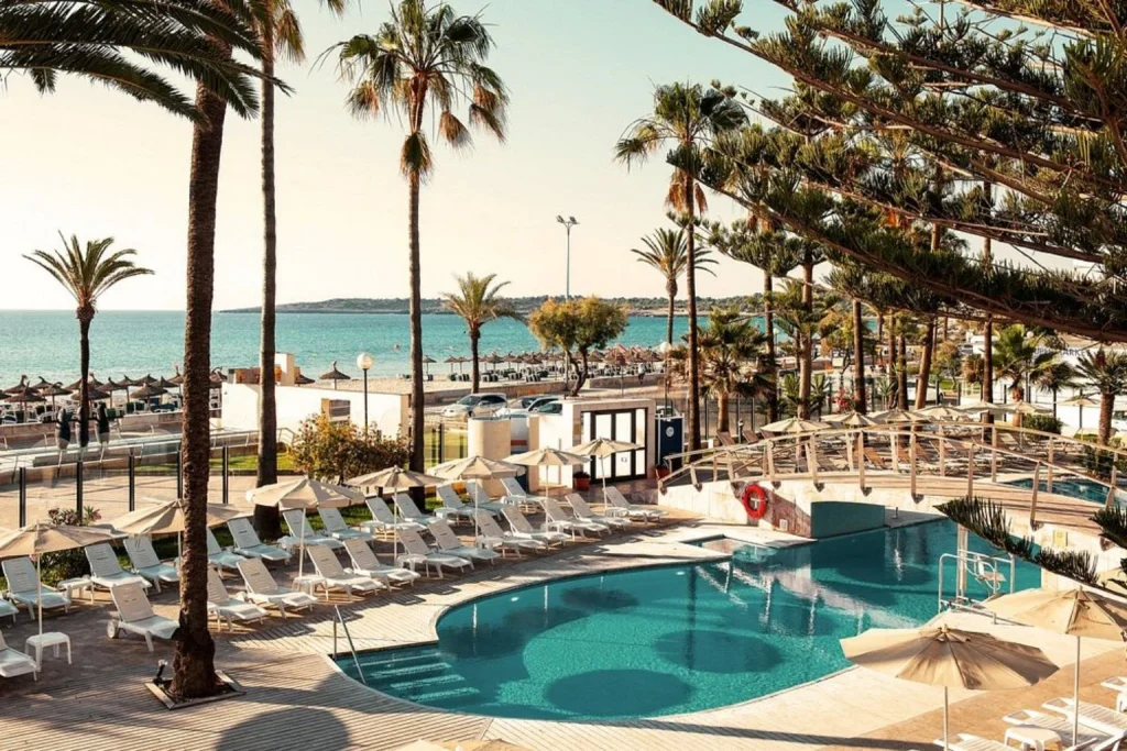 Seafront pool area at CM Playa del Moro overlooking Cala Millor Beach in Majorca.