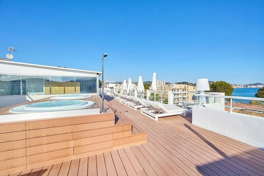 Rooftop terrace with hot tub, sun loungers, and sea views at Cupido Boutique Hotel in Peguera, Majorca.