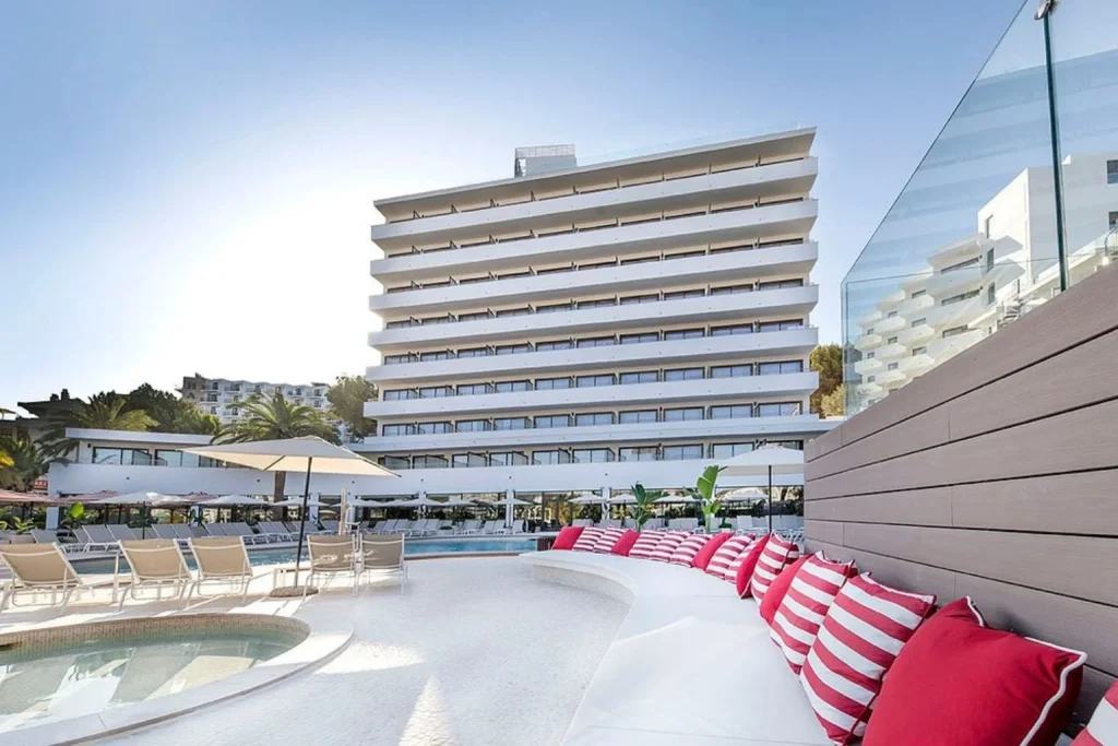 Outdoor swimming pool with in-water loungers at FERGUS Style Tobago in Palma Nova, Mallorca.