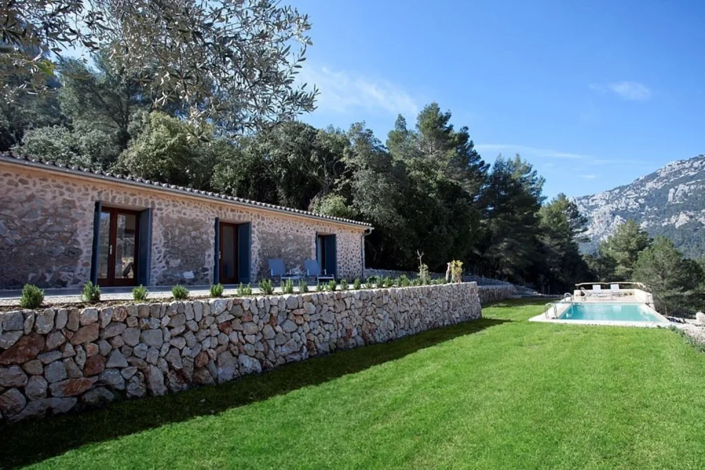 Garden and outdoor pool with mountain view at Finca Hotel Son Palou in Orient, Mallorca.
