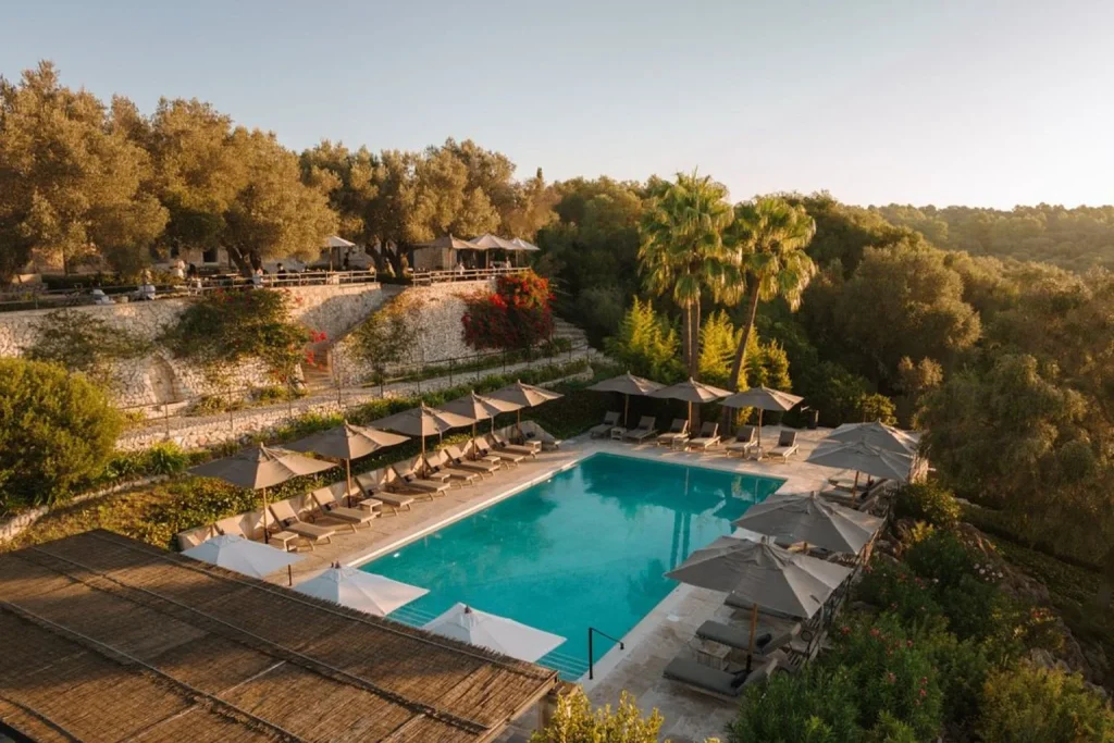 Outdoor swimming pool surrounded by olive groves and countryside views at Finca Serena Mallorca in Montuïri.