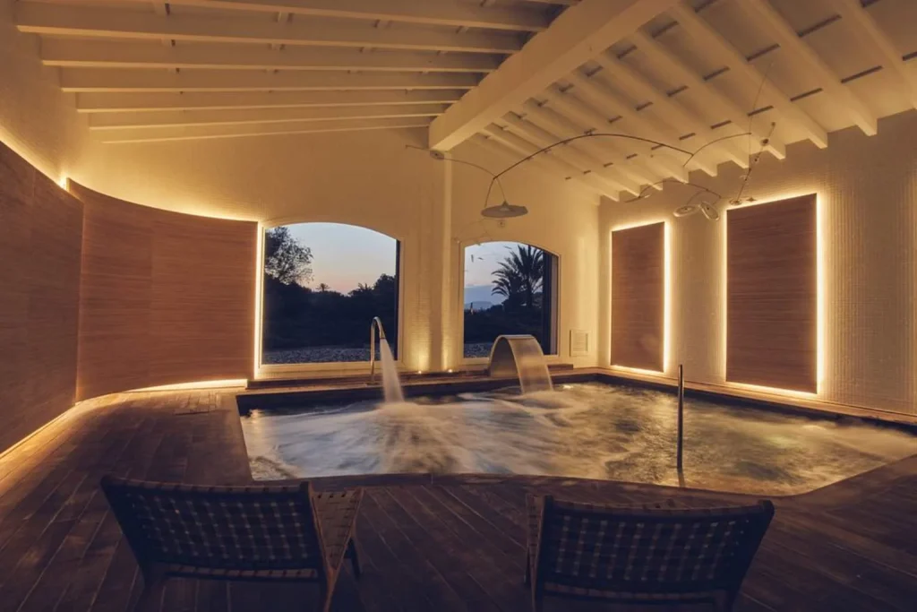 Indoor thermal spa pool with hydrotherapy jets and ambient lighting at Fontsanta Hotel Thermal Spa & Wellness near Colònia de Sant Jordi, Mallorca.