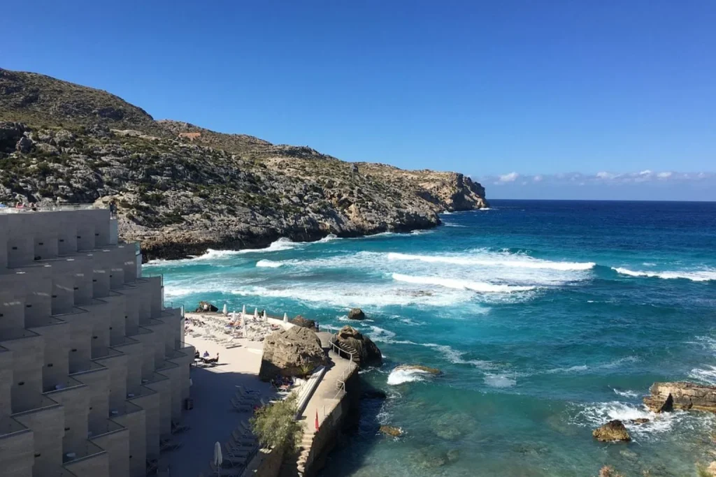 Seafront hotel and rocky coastline at Globales Simar in Cala Sant Vicenç, Mallorca