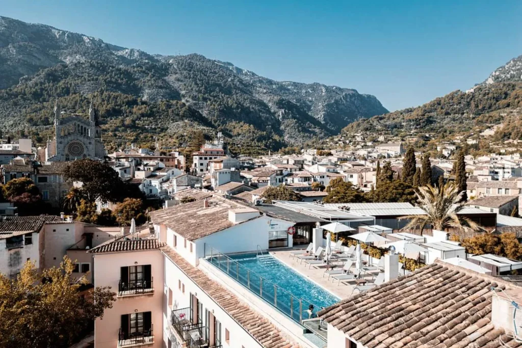 Rooftop infinity pool overlooking Sóller's historic town center and the Tramuntana mountains at Gran Hotel Sóller, Mallorca.