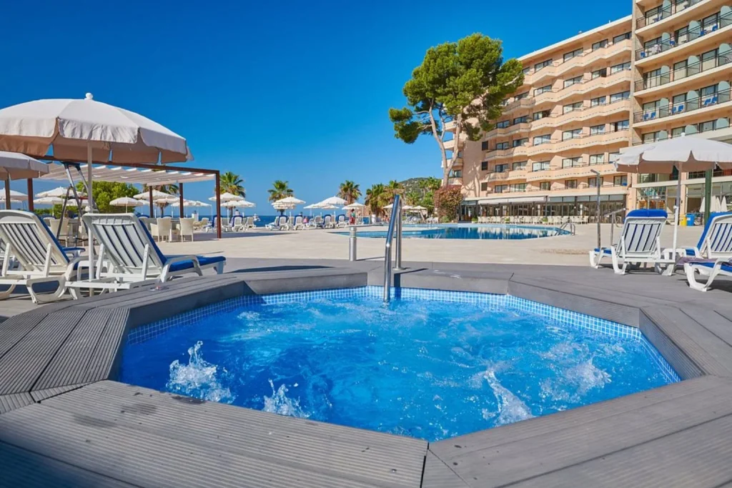 Outdoor swimming pool and hot tub with sun terrace at Grupotel Playa Camp de Mar in Camp de Mar, Mallorca.