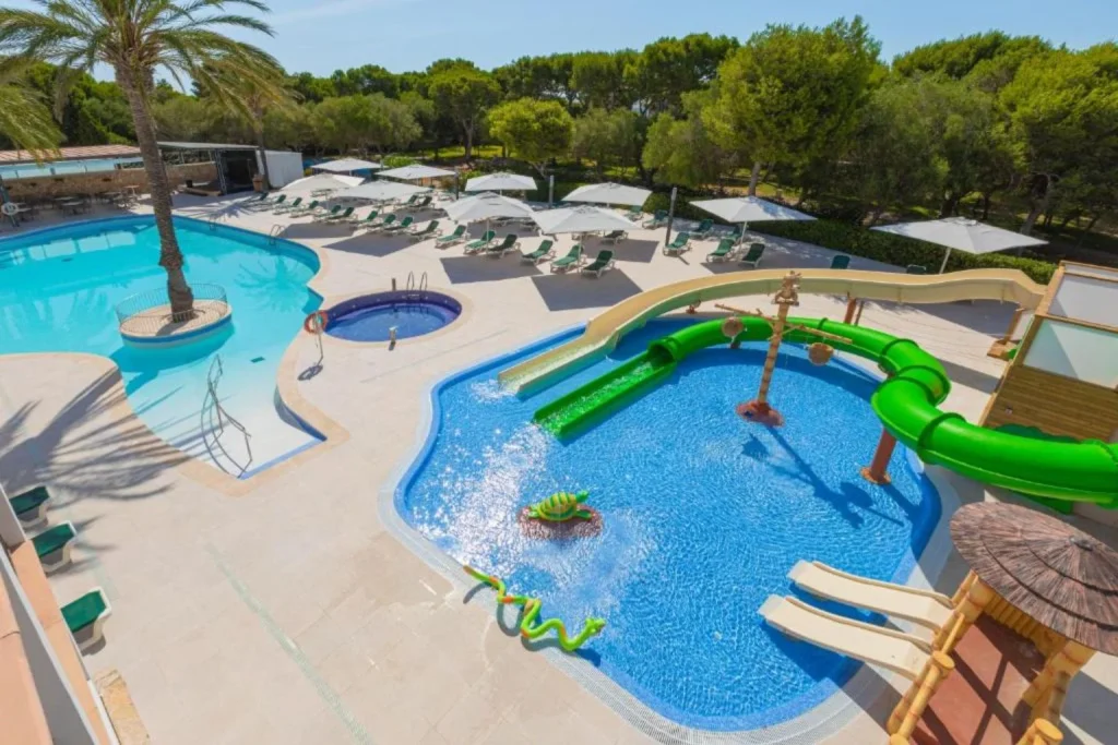 Family swimming pool with a water slide at Hotel Cala d'Or Playa in Cala d'Or, Mallorca.
