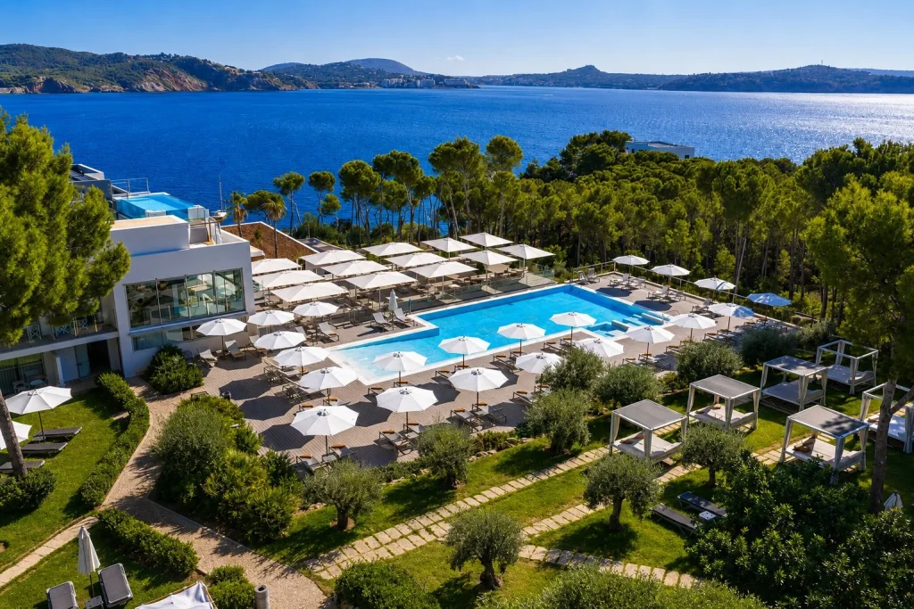 Large outdoor swimming pool with sea views and landscaped gardens at Hotel Coronado Thalasso & Spa in Peguera, Majorca.