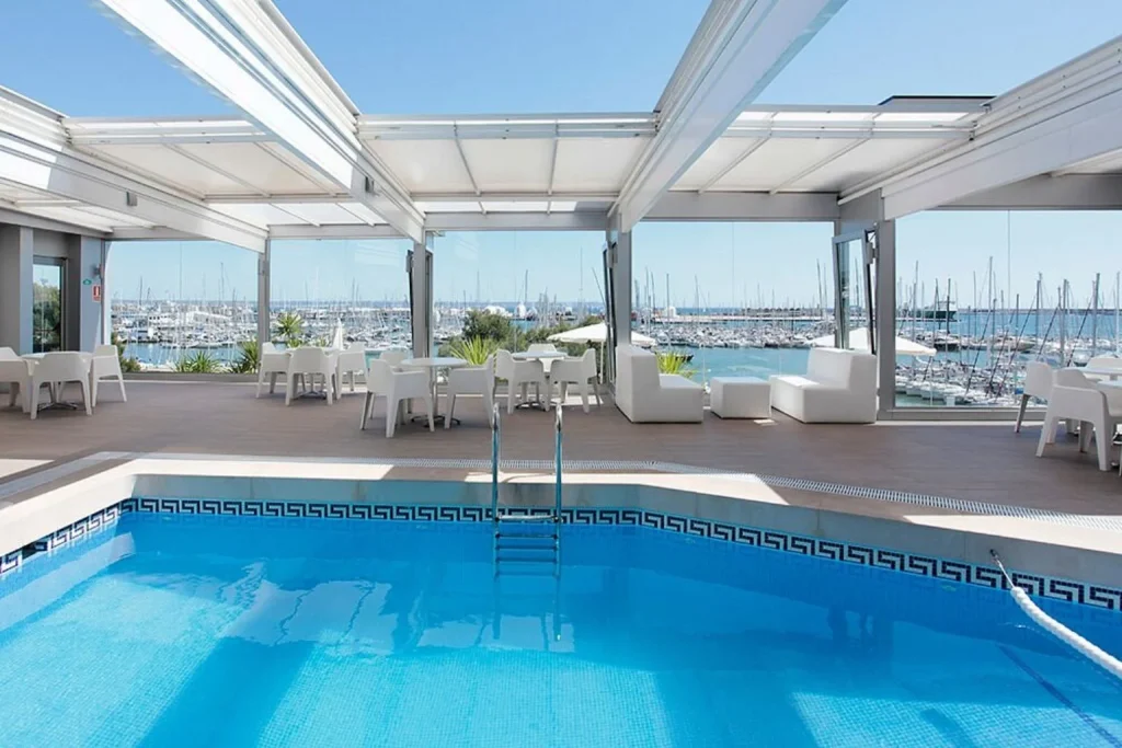 Indoor swimming pool with views of Palma Marina at Hotel Costa Azul in Palma, Mallorca.
