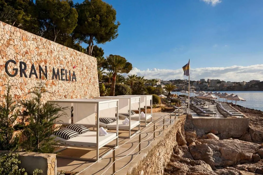 Beachfront relaxation area with Mediterranean sea views at Hotel de Mar Gran Meliá in Illetes, Majorca.