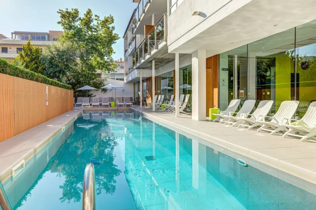 Contemporary outdoor pool and sun terrace at Hotel Miramar Mallorca in the heart of Port de Pollença.