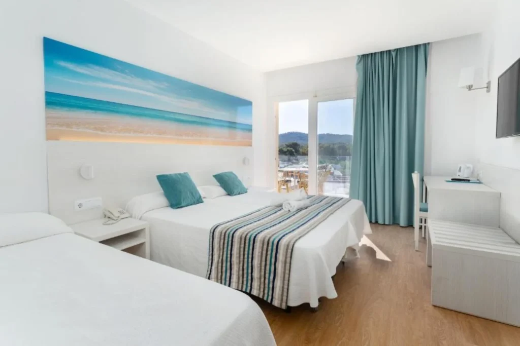 Modern guest room with private balcony at Hotel Playas de Paguera in Peguera, Majorca.