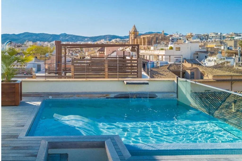 Rooftop swimming pool overlooking the historic skyline of Palma de Mallorca at Hotel Tres.