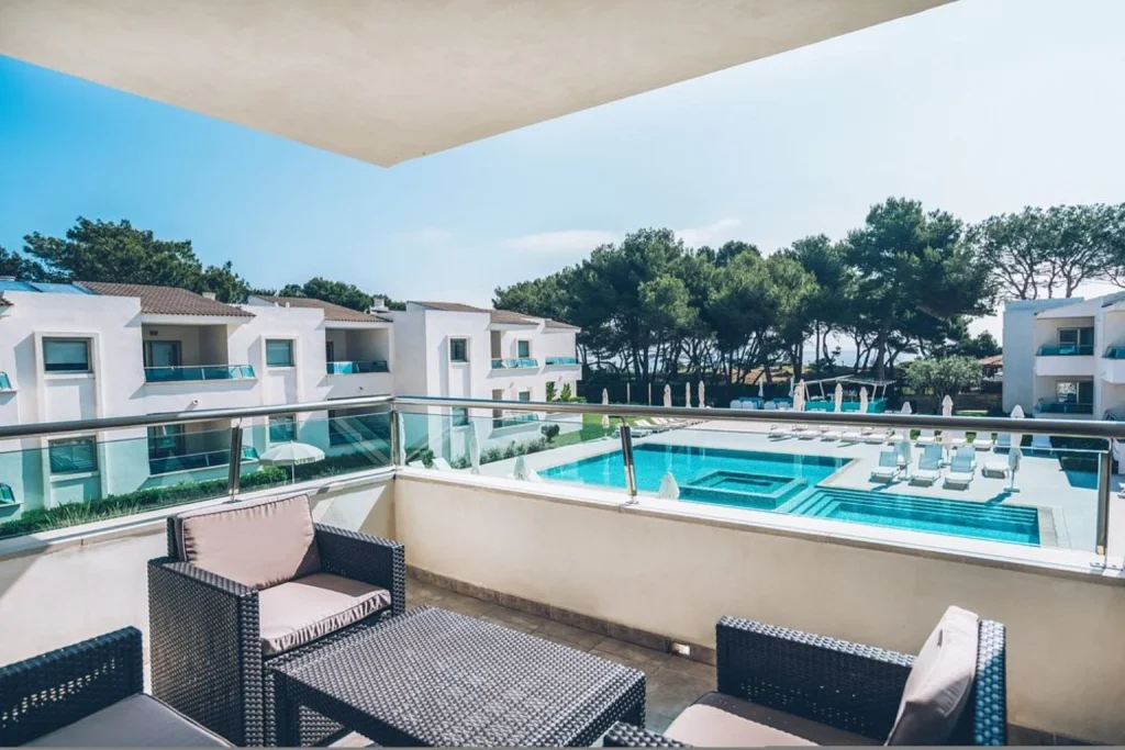 Balcony view overlooking the swimming pool at Iberostar Selection Playa de Muro Village in Playa de Muro, Mallorca