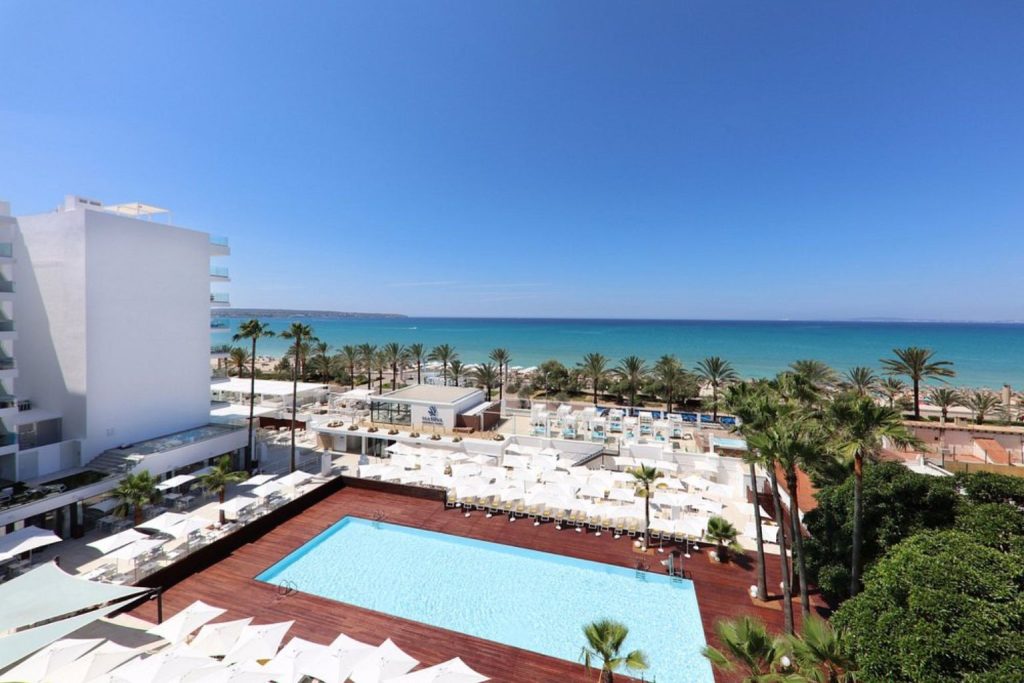 Oceanfront outdoor swimming pool overlooking Playa de Palma Beach at Iberostar Waves Bahía de Palma in Playa de Palma, Mallorca.