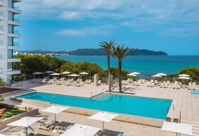 Seafront pool with Mediterranean coastline views at Iberostar Waves Cala Millor in Cala Millor, Mallorca.