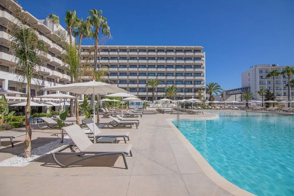 Main pool and spacious sun terrace overlooking the hotel building at INNSiDE by Meliá Alcudia in Alcudia.