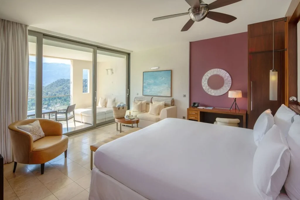 Spacious guest room with a private balcony and Tramuntana Mountain views at Jumeirah Mallorca in Port de Sóller, Mallorca.
