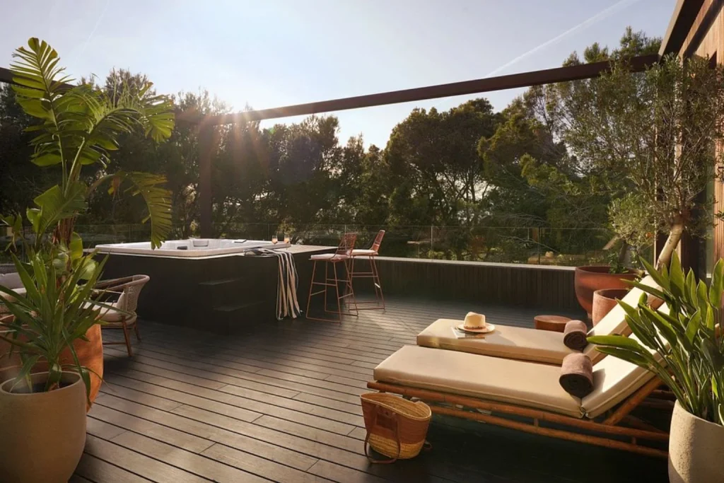 Private terrace suite with a hot tub, sun loungers, and peaceful garden views at Kimpton Aysla Mallorca by IHG in Mallorca, Spain.